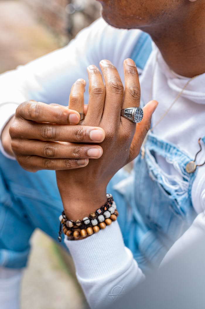 Detailed image of hands adorned with a ring and bracelets, showcasing style and fashion.